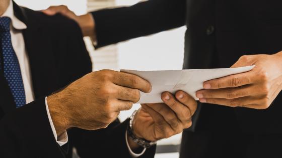 Business person receiving envelope