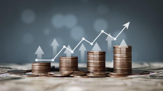 Stacks of coins and upward chart