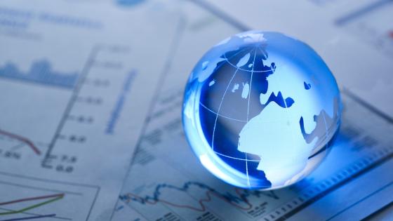 Glass globe on financial charts