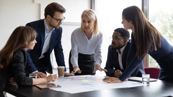 manager leading office team meeting