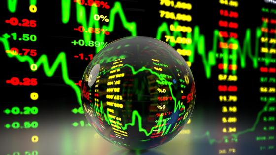 Crystal ball in front of financial charts