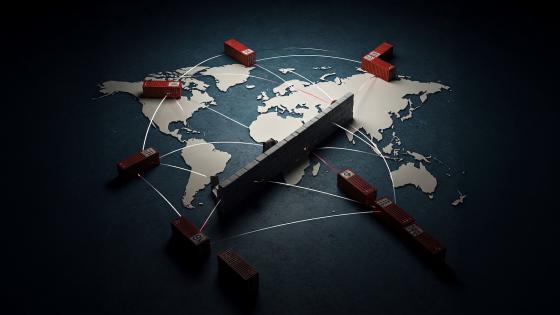 Shipping containers on world map with wall in-between