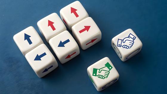 six white dice with directional arrows arranged on a dark gray background