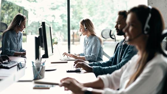 Workers in office using headsets